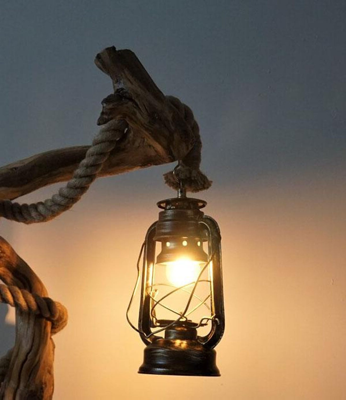 A handcrafted rustic driftwood floor lamp with natural wood base and a beige linen shade, positioned in a living room corner creating warm ambient lighting perfect for both home and office settings-1