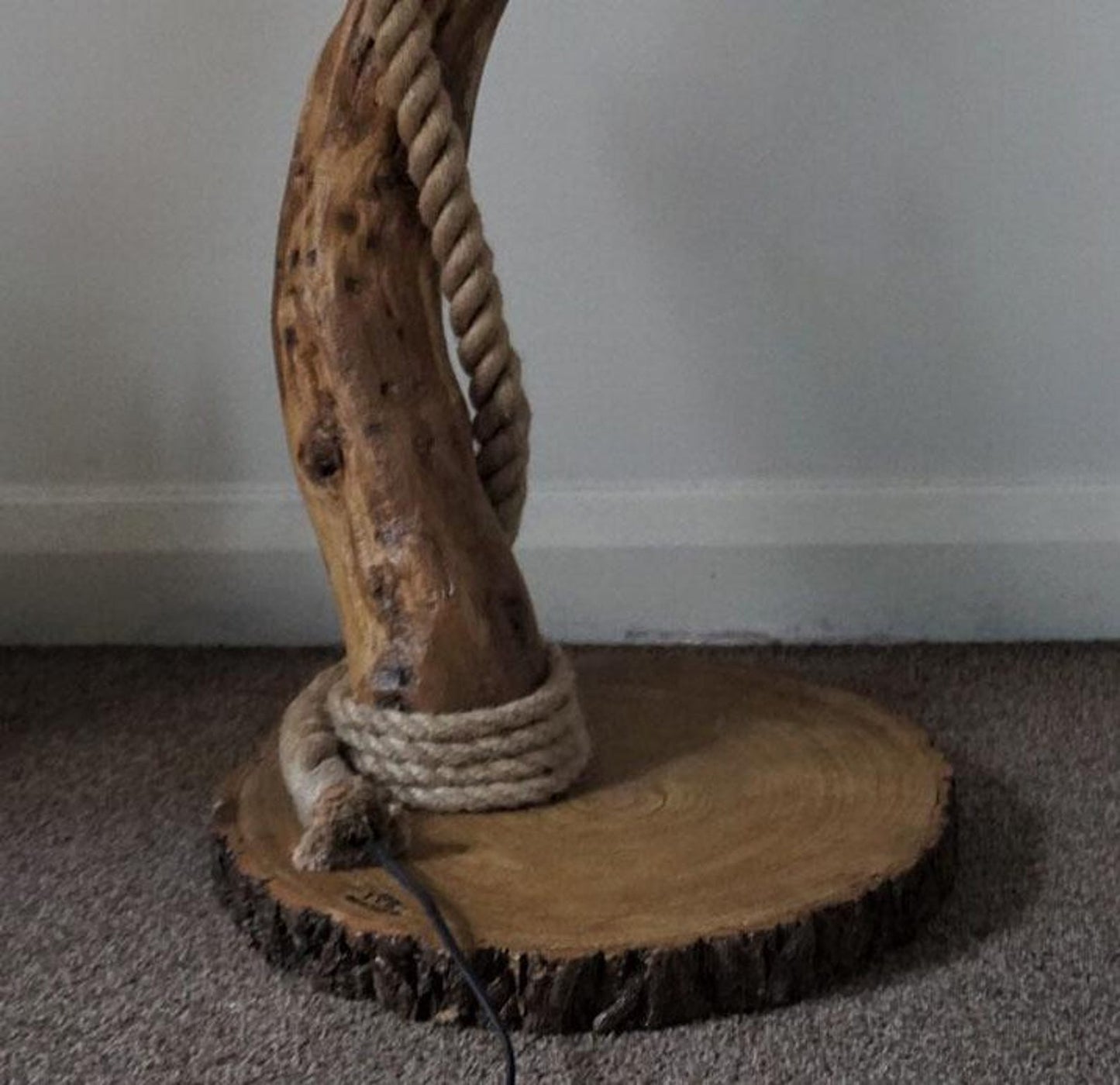A handcrafted rustic driftwood floor lamp with natural wood base and a beige linen shade, positioned in a living room corner creating warm ambient lighting perfect for both home and office settings-2