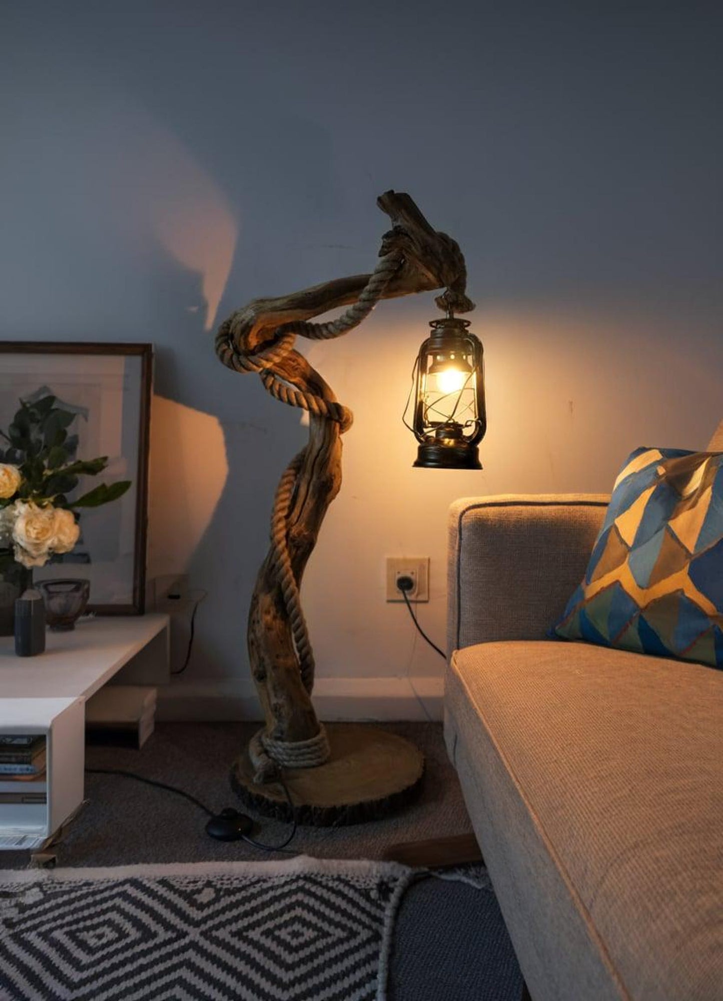 A handcrafted rustic driftwood floor lamp with natural wood base and a beige linen shade, positioned in a living room corner creating warm ambient lighting perfect for both home and office settings-3