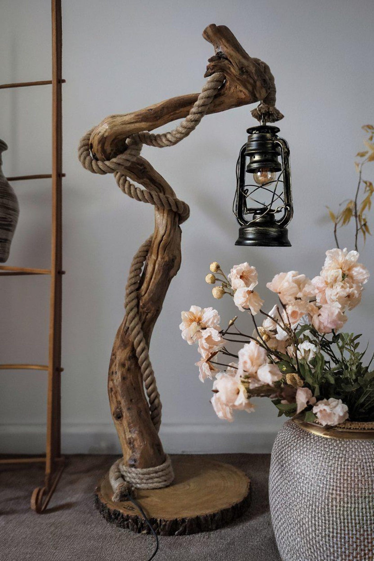 A handcrafted rustic driftwood floor lamp with natural wood base and a beige linen shade, positioned in a living room corner creating warm ambient lighting perfect for both home and office settings-4