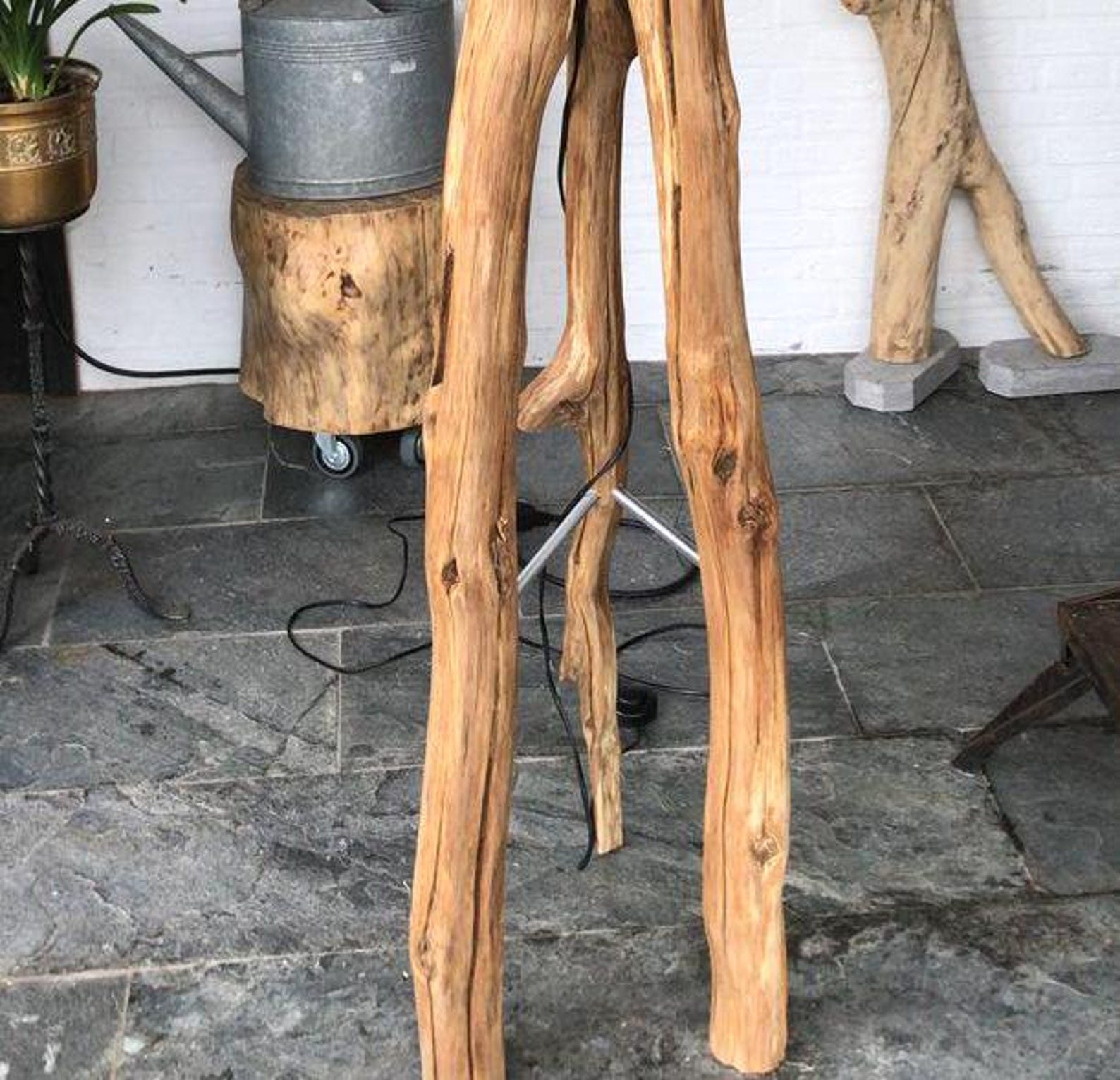 A rustic natural‑wood floor lamp made from a tree trunk, styled in a corner with a black lampshade combining organic texture with warm ambient lighting in minimalist or farmhouse interiors-3