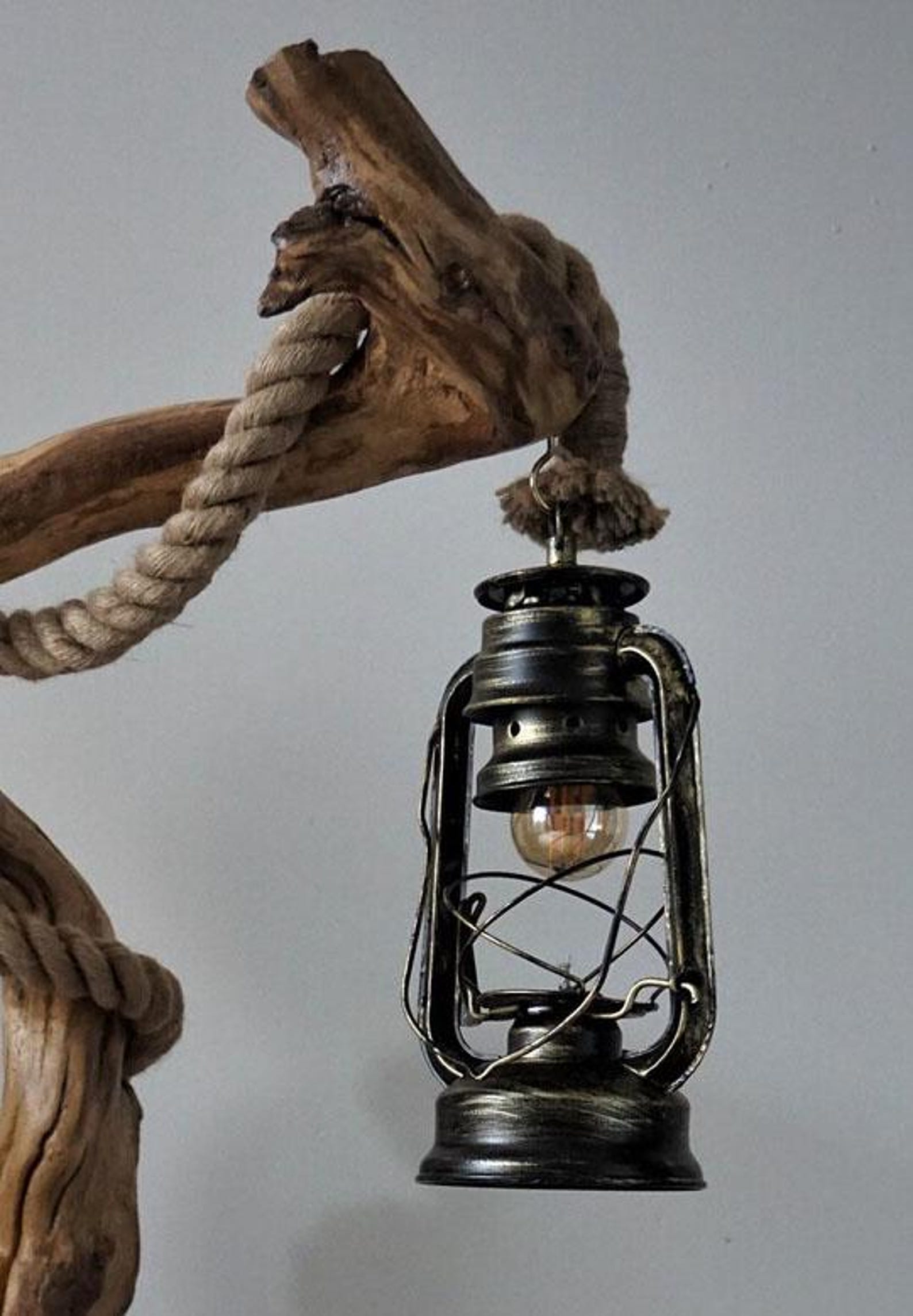 A handcrafted rustic driftwood floor lamp with natural wood base and a beige linen shade, positioned in a living room corner creating warm ambient lighting perfect for both home and office settings-5