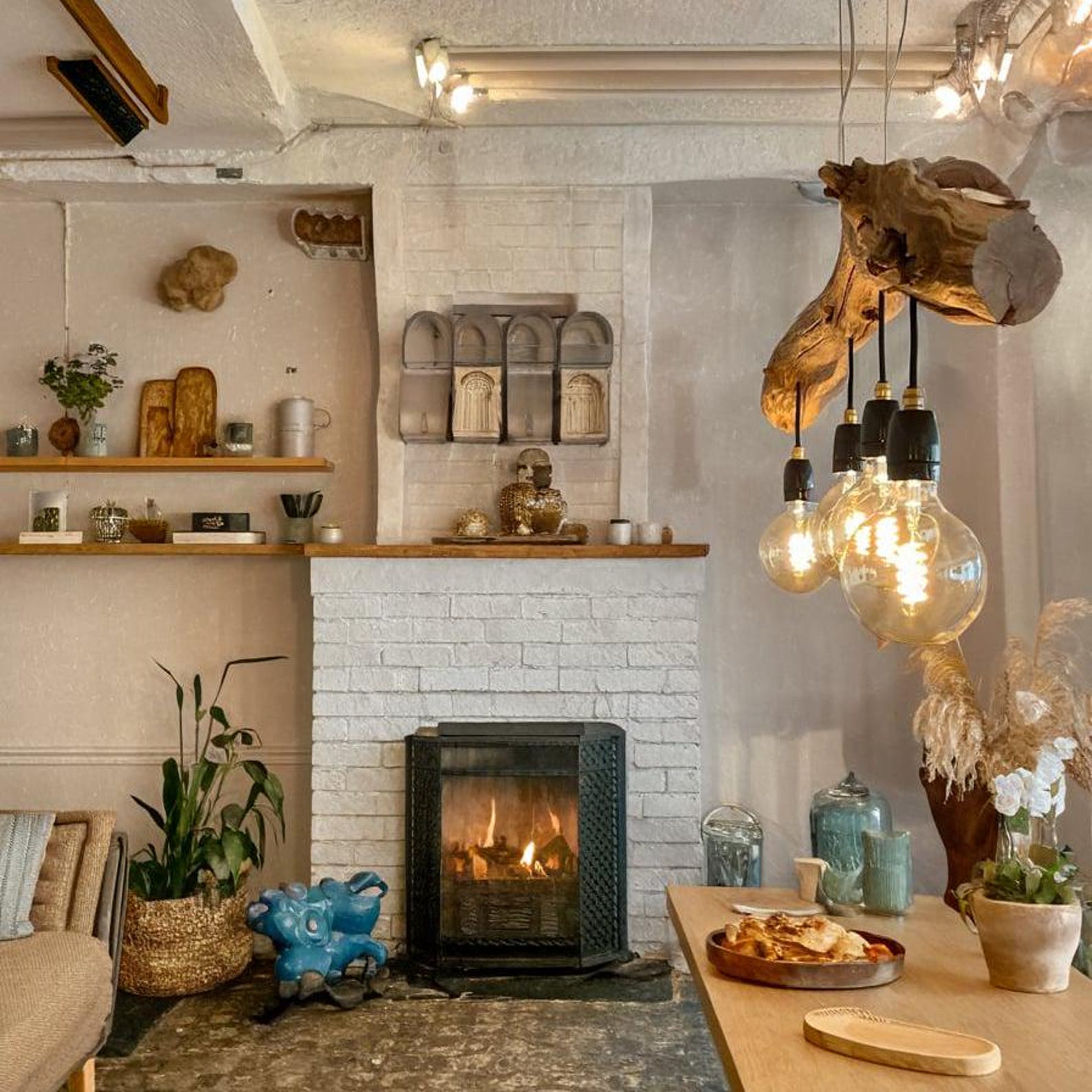 A rustic driftwood ceiling lamp crafted from natural wood branches, suspended by cords and featuring exposed warm-tone bulb lights—ideal for bringing organic farmhouse charm to indoor spaces-1