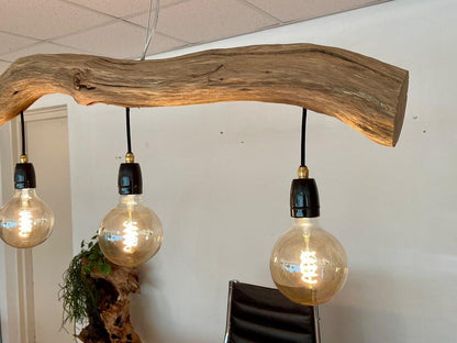 A rustic driftwood ceiling lamp crafted from natural wood branches, suspended by cords and featuring exposed warm-tone bulb lights—ideal for bringing organic farmhouse charm to indoor spaces-4